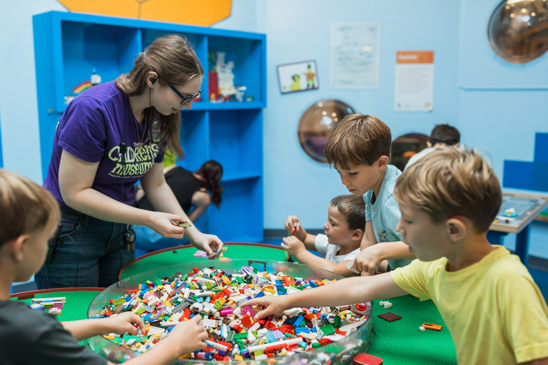 Museum employee engaging group of students in an activity