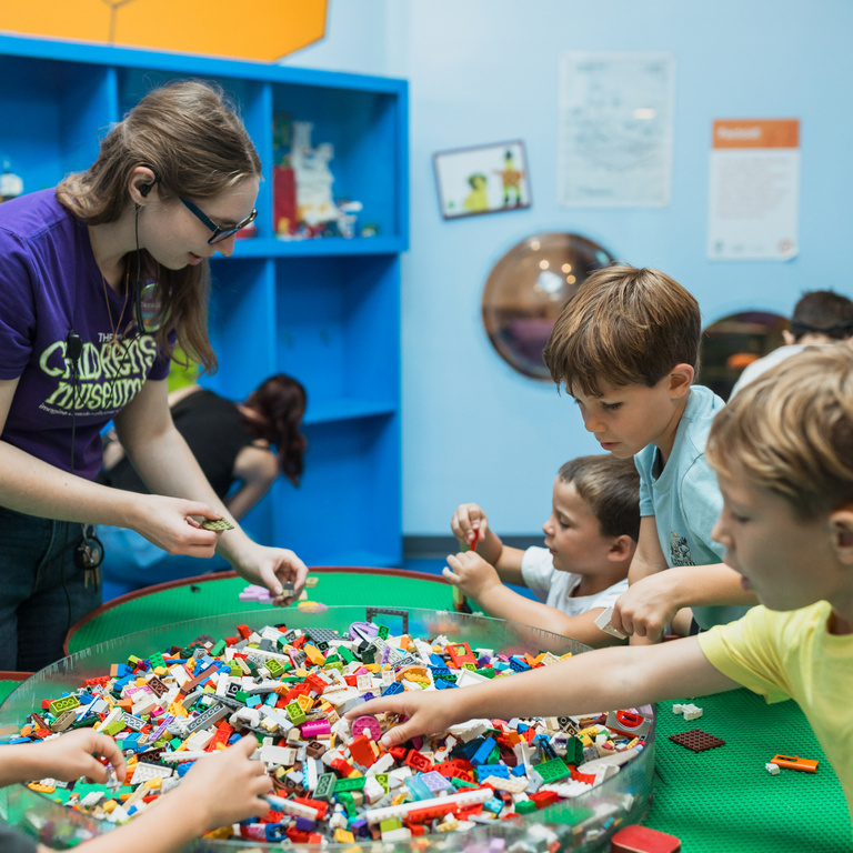 Museum employee engaging group of students in an activity