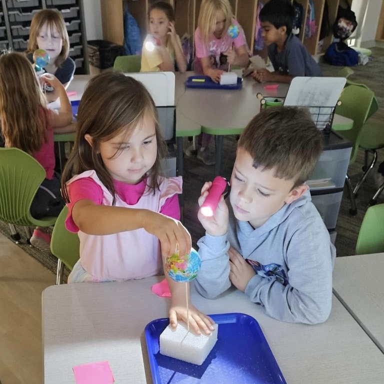 Elementary-aged students working together on a science activity