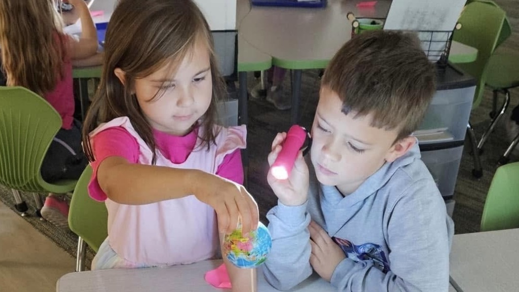 Elementary-aged students working together on a science activity
