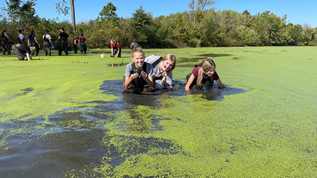 Students wade in water